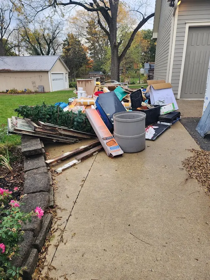 Dumpster being loaded with debris for Estate Cleanout Dumpster Rental in Wales